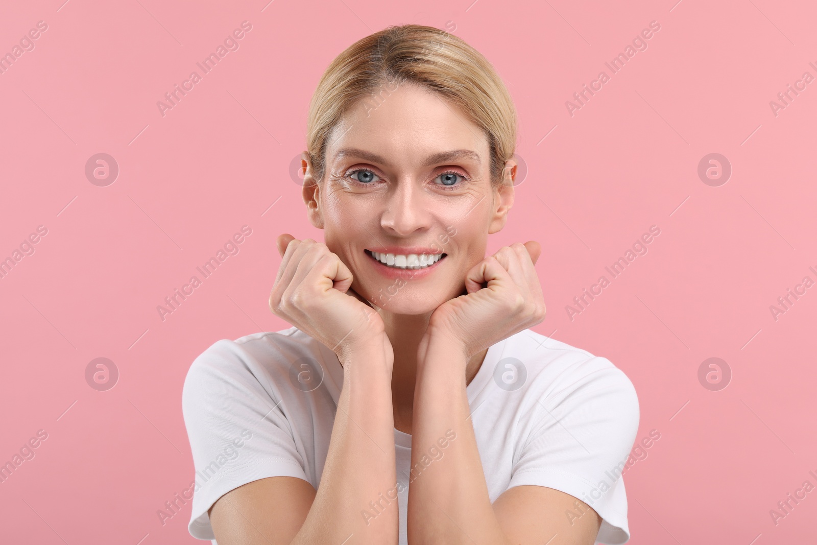 Photo of Woman with clean teeth smiling on pink background