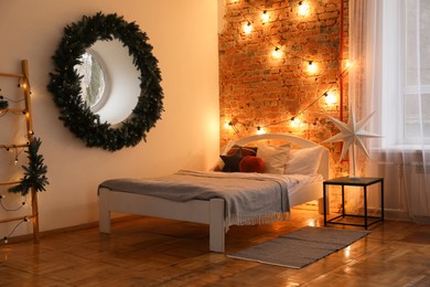 Photo of Cozy bedroom with stylish Christmas decor. Interior design