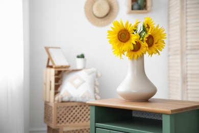 Photo of Bouquet of beautiful sunflowers on table indoors. Space for text