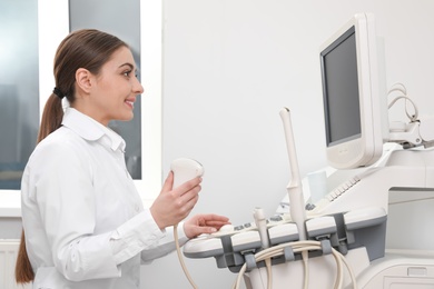 Photo of Professional sonographer using modern ultrasound machine in clinic