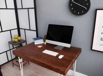 Comfortable workplace with computer on desk in home office