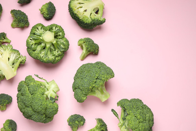 Photo of Fresh broccoli on pink background, flat lay. Space for text