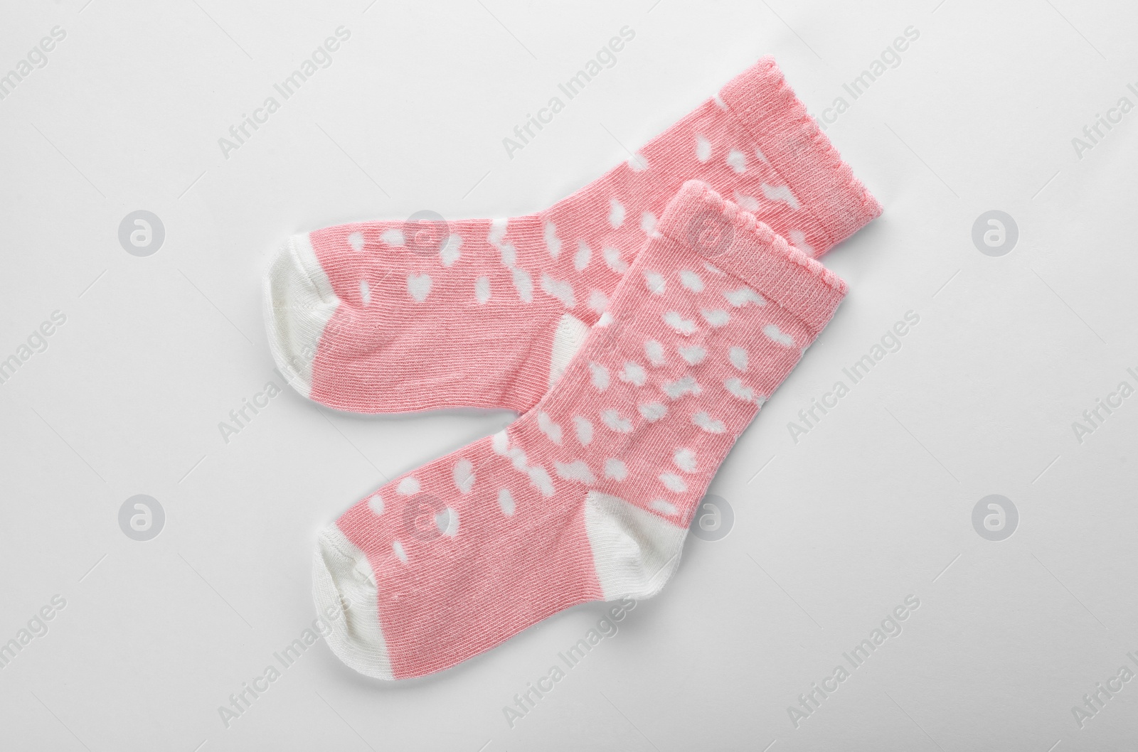 Photo of Cute child socks on white background, top view