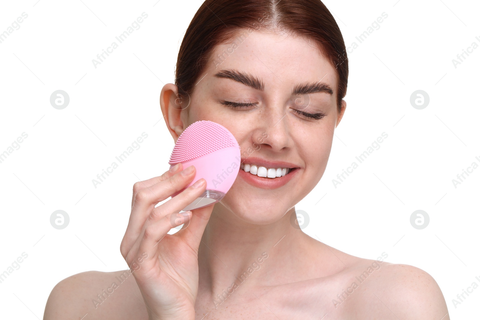 Photo of Washing face. Young woman with cleansing brush on white background