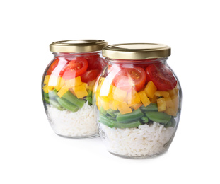 Glass jars with healthy meal isolated on white