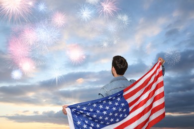 Image of 4th of July - Independence day of America. Man with national flag of United States enjoying fireworks in sky