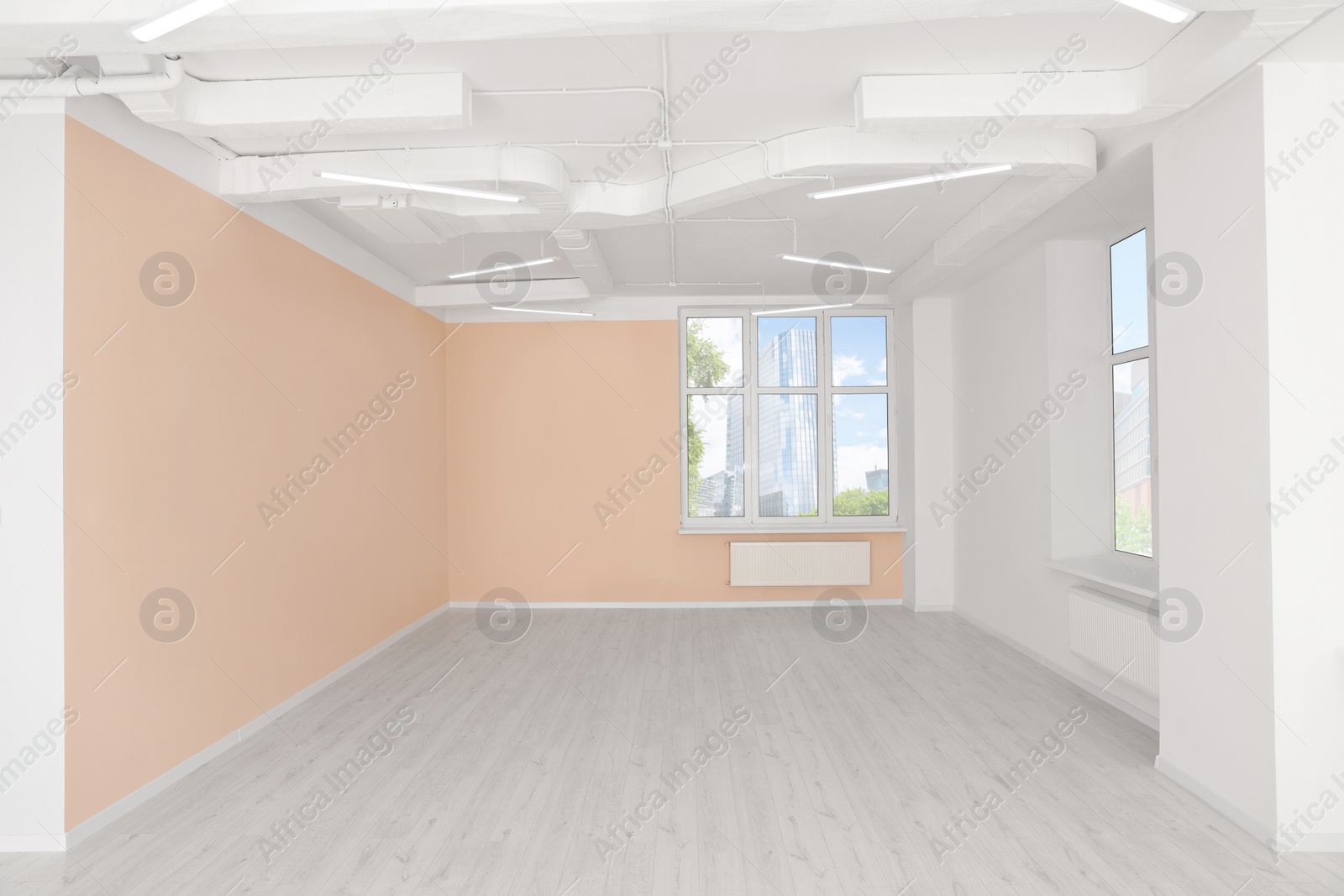 Photo of New empty office room with clean windows and beige walls