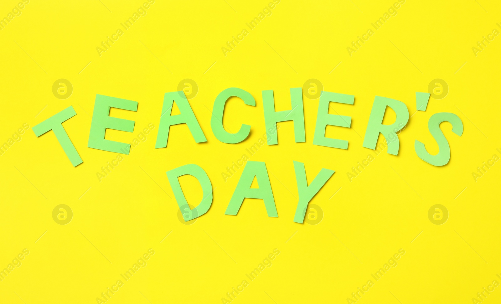 Photo of Words TEACHER'S DAY on yellow background, flat lay