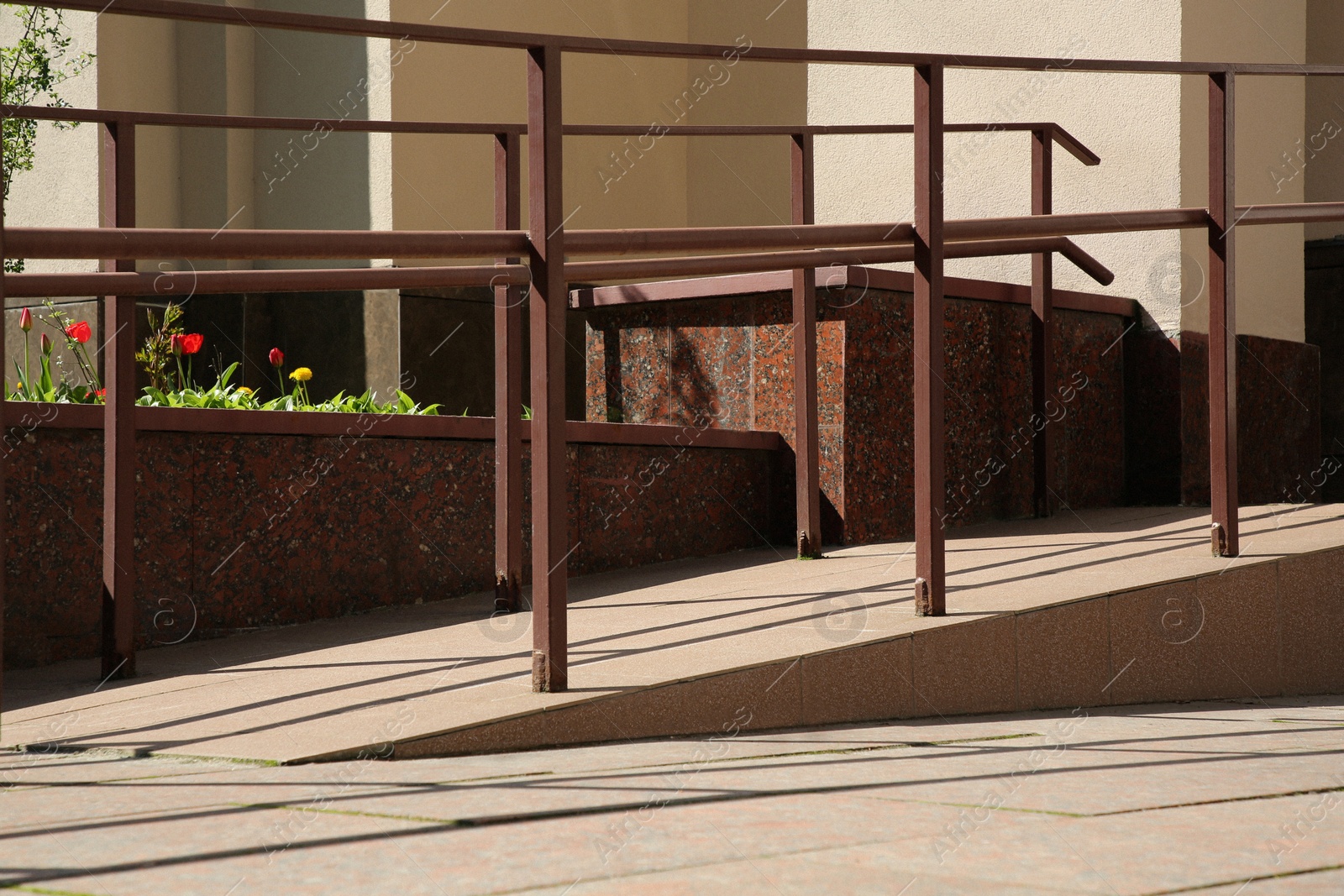 Photo of Ramp with metal handrails near building outdoors