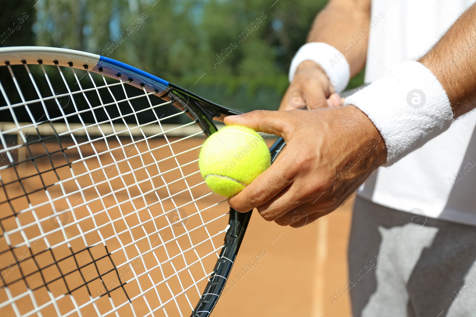 Photo of Sportsman preparing to serve tennis ball at court, closeup