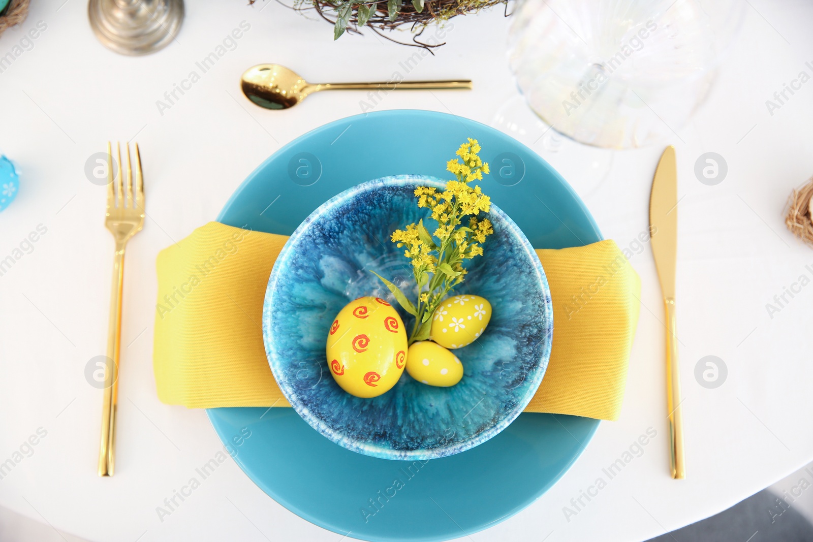 Photo of Festive Easter table setting with beautiful floral decor and eggs, flat lay