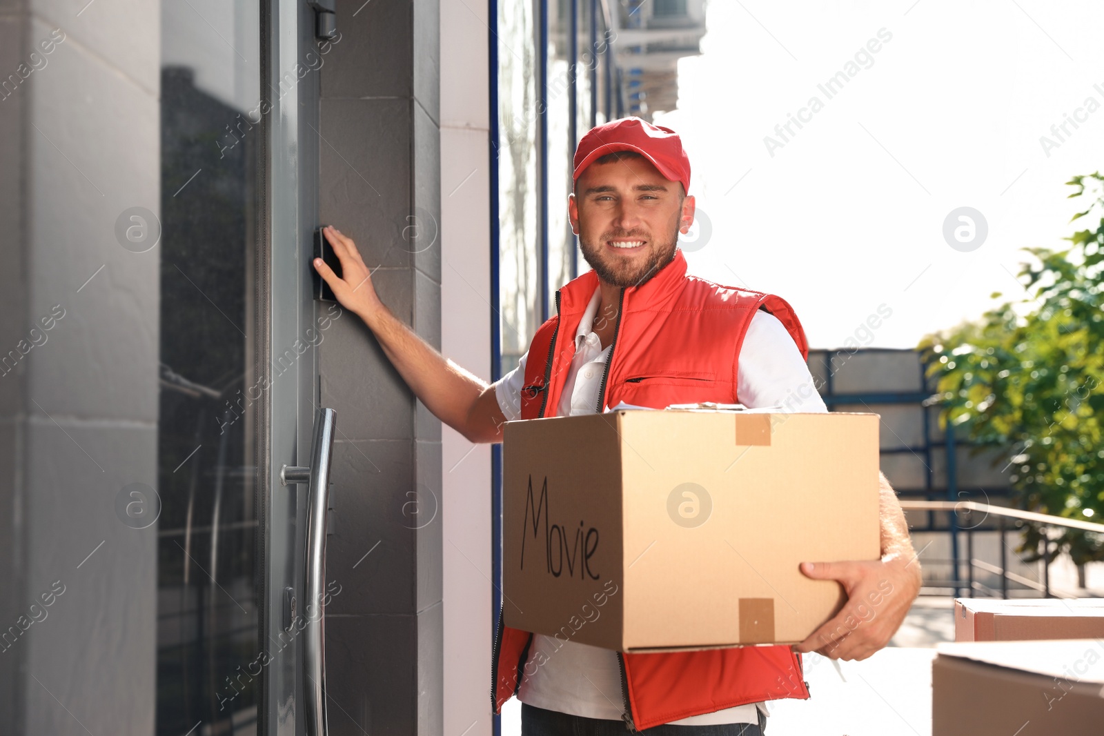 Photo of Male mover with parcel box near entrance