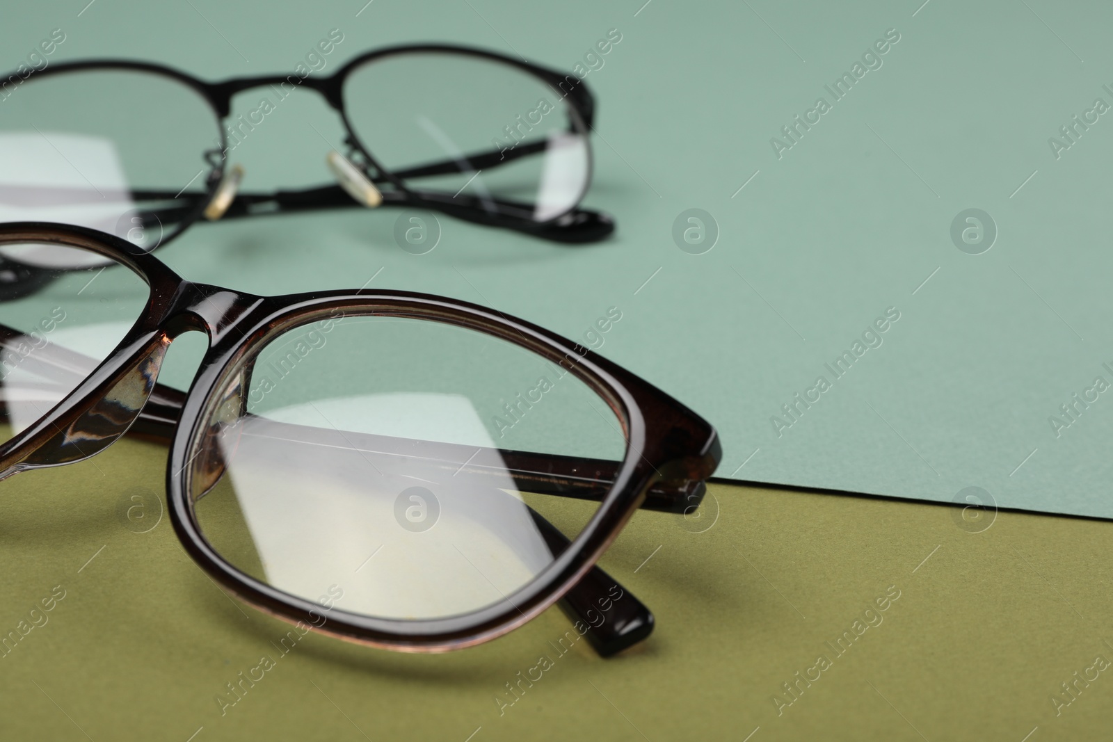 Photo of Glasses on color background, closeup. Space for text