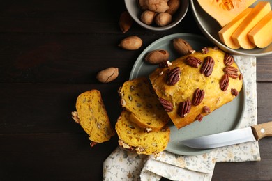 Photo of Delicious pumpkin bread with pecan nuts on wooden table, flat lay. Space for text