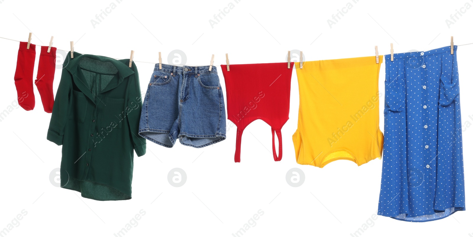 Photo of Different clothes drying on laundry line against white background