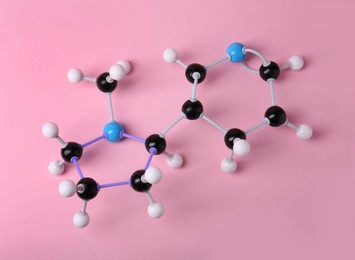 Photo of Molecule of nicotine on pink background, top view. Chemical model