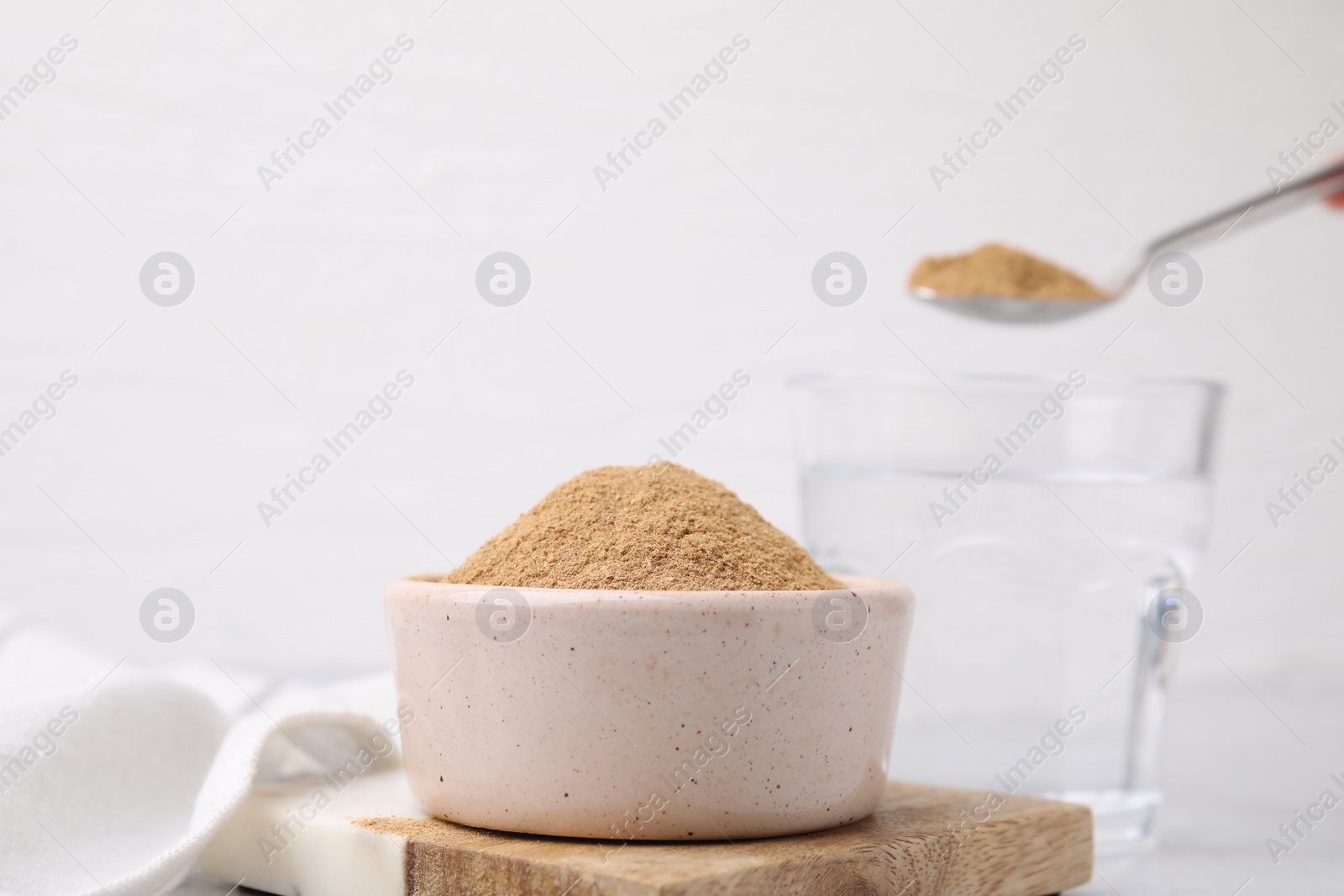 Photo of Dietary fiber. Psyllium husk powder in bowl on table