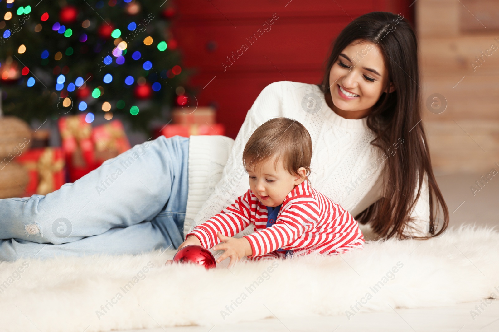 Photo of Mother and her cute baby at home. Christmas celebration