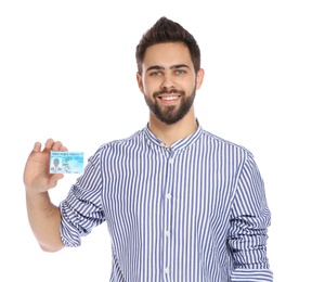 Happy young man with driving license on white background