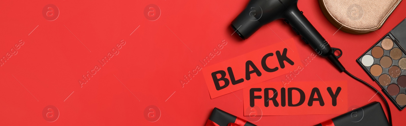 Image of Cosmetics, bag, hairdryer, gift boxes and phrase Black Friday on red background, flat lay with space for text. Banner design