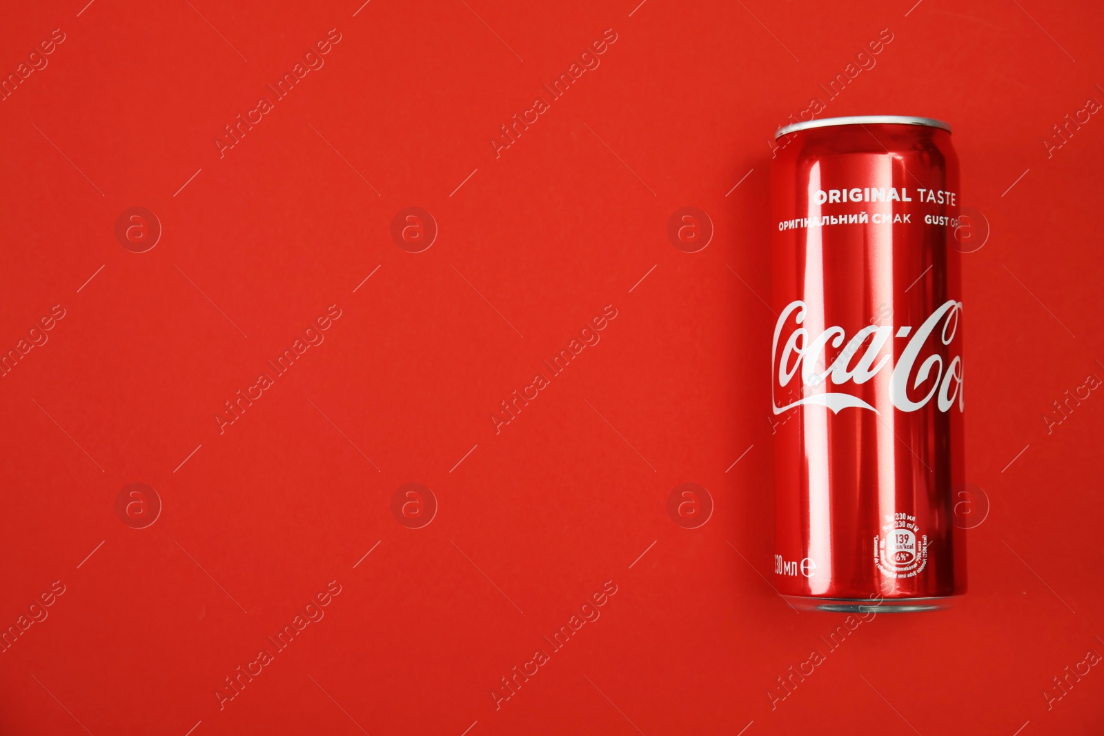 Photo of MYKOLAIV, UKRAINE - NOVEMBER 14, 2018: Coca-Cola can on color background, top view. Space for text