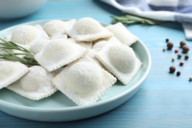 Photo of Homemade uncooked ravioli on blue wooden table, closeup