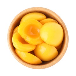 Photo of Halves of canned peaches in wooden bowl isolated on white, top view