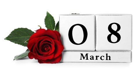 Wooden block calendar with date 8th of March and rose on white background. International Women's Day