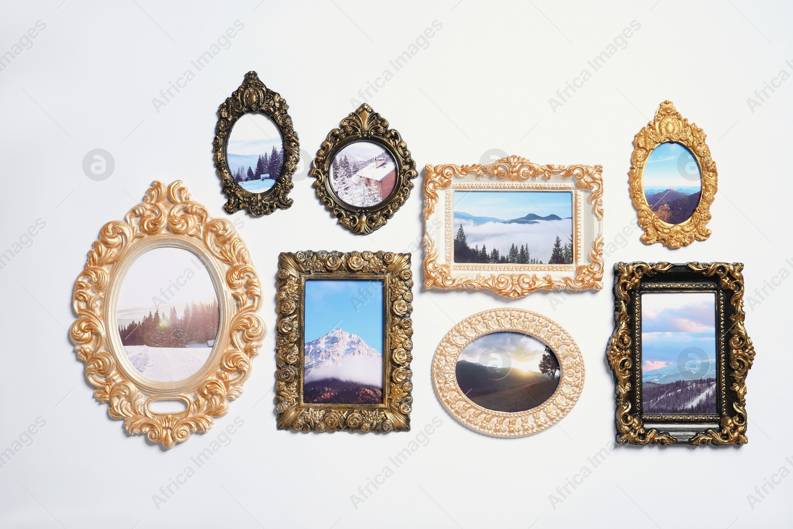 Photo of Vintage frames with photos of beautiful landscapes hanging on white wall