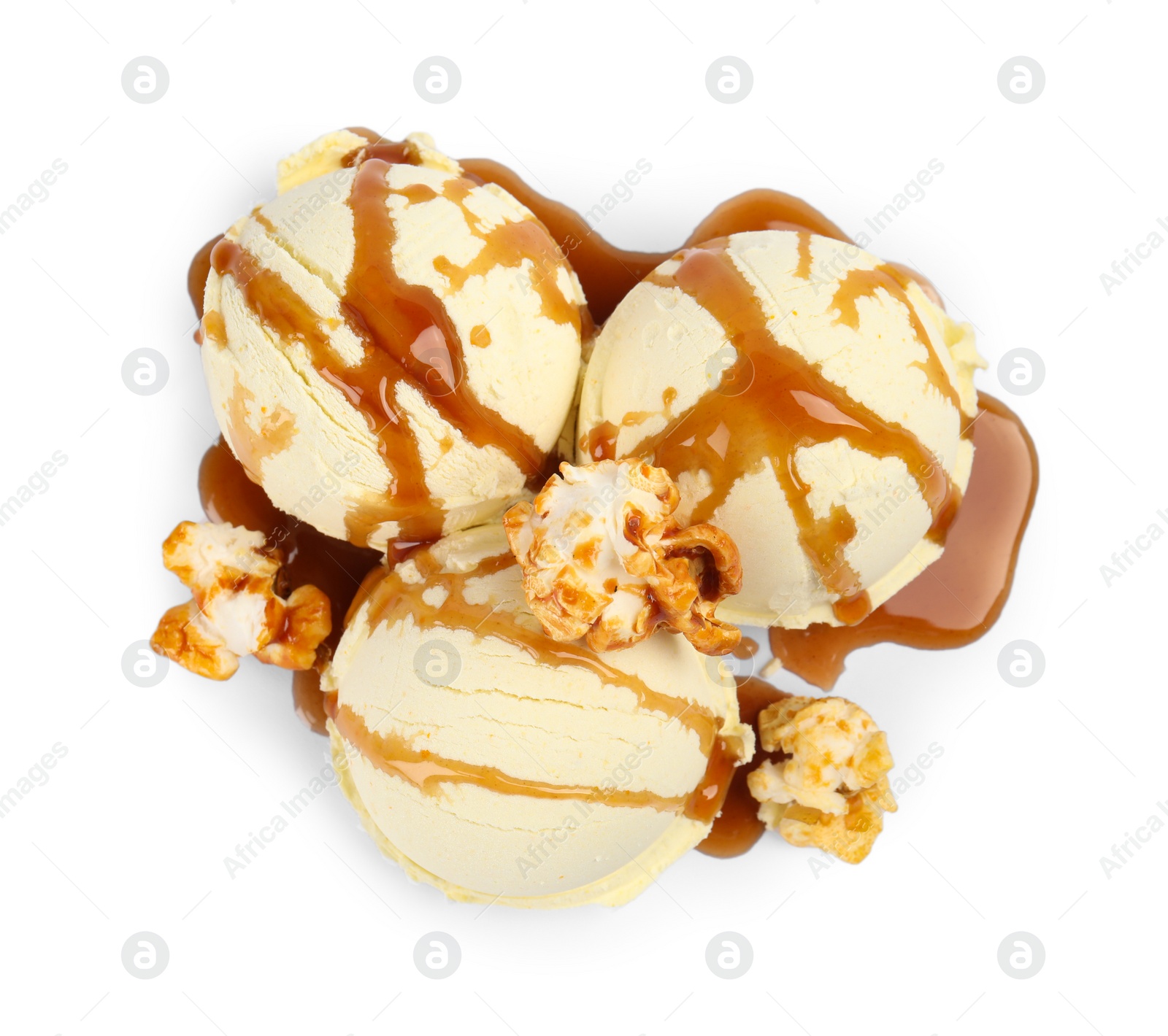 Photo of Delicious ice cream with caramel popcorn and sauce on white background, top view