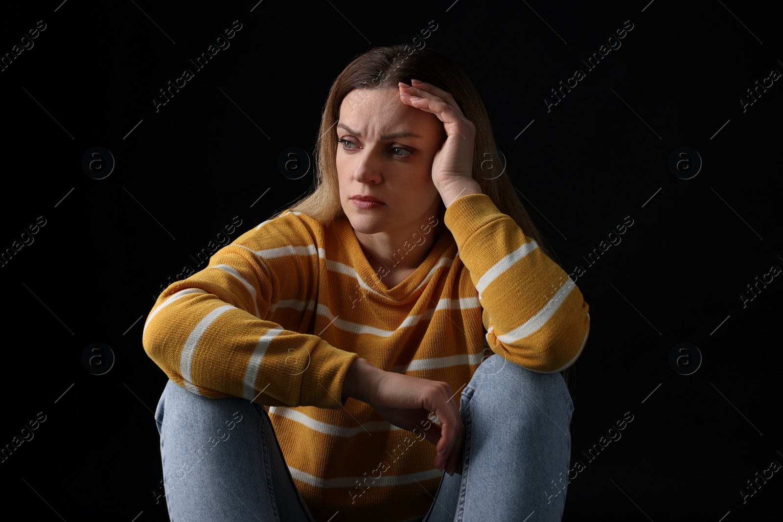 Photo of Portrait of sad woman on black background