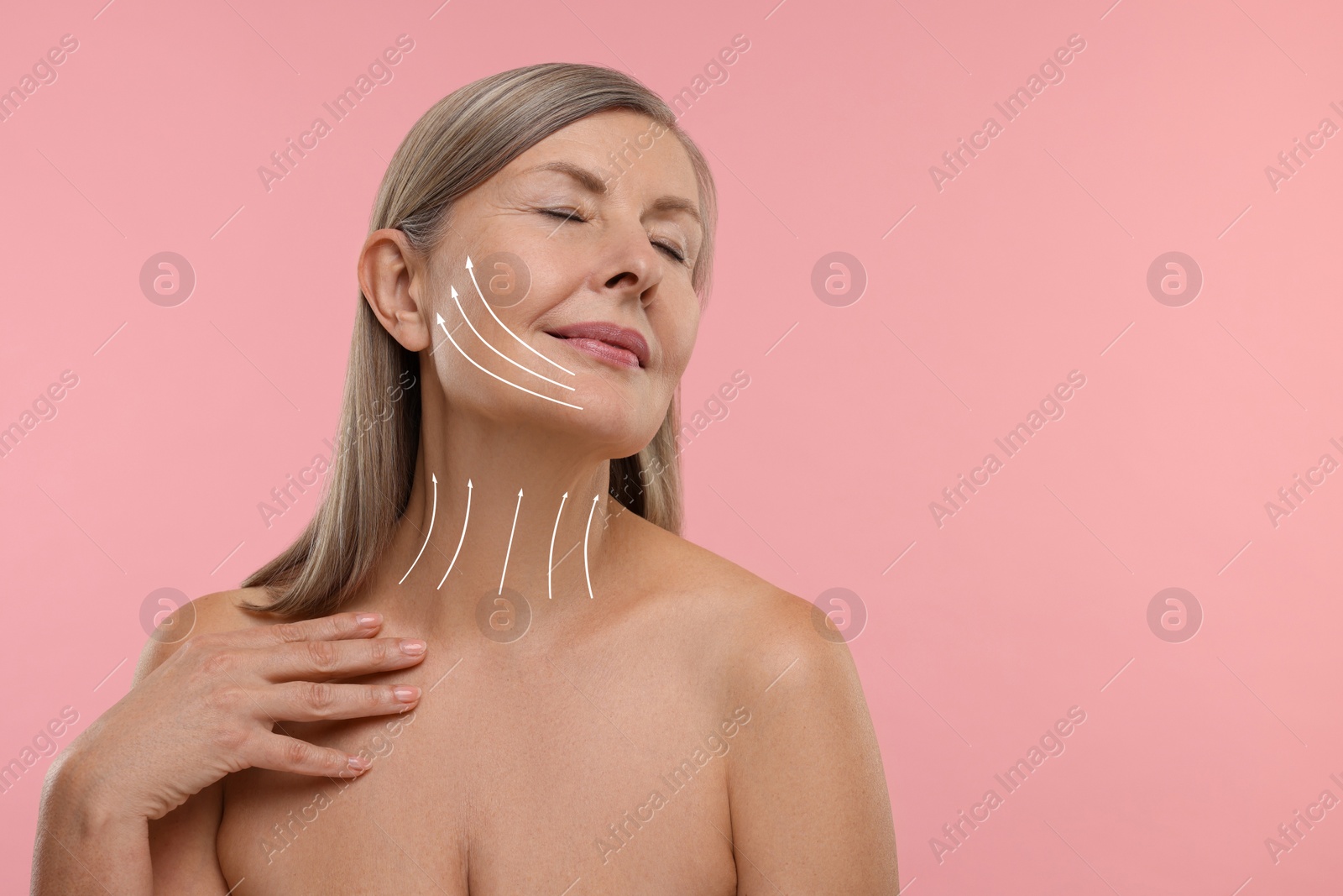 Image of Woman with perfect skin after cosmetic treatment on pink background, space for text. Lifting arrows on her neck and face