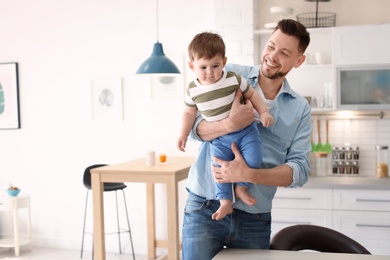 Photo of Dad spending time with his son in kitchen