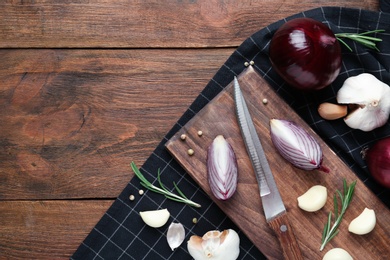 Photo of Flat lay composition with garlic, onions and space for text on wooden background