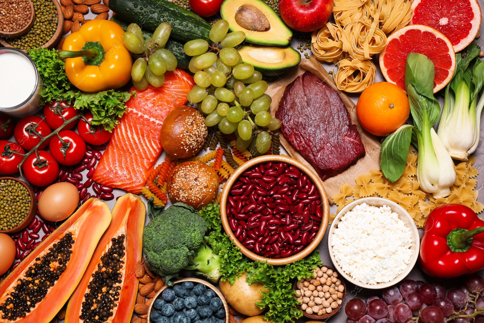 Photo of Different products on grey table, top view. Healthy food and balanced diet