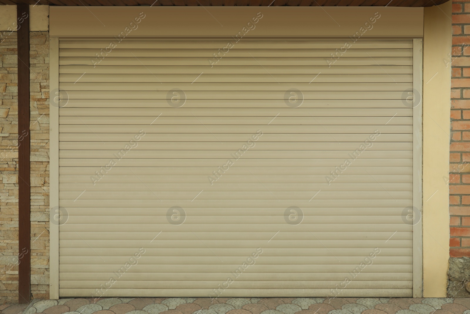 Photo of Building with white roller shutter garage door