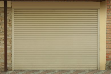 Building with white roller shutter garage door