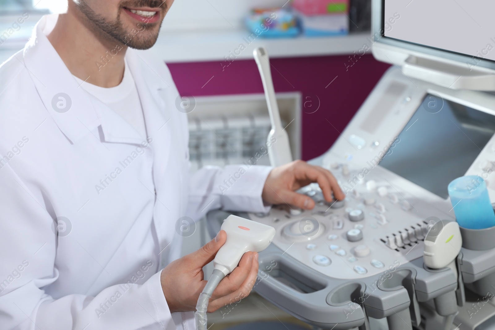 Photo of Sonographer using modern ultrasound machine in clinic, closeup