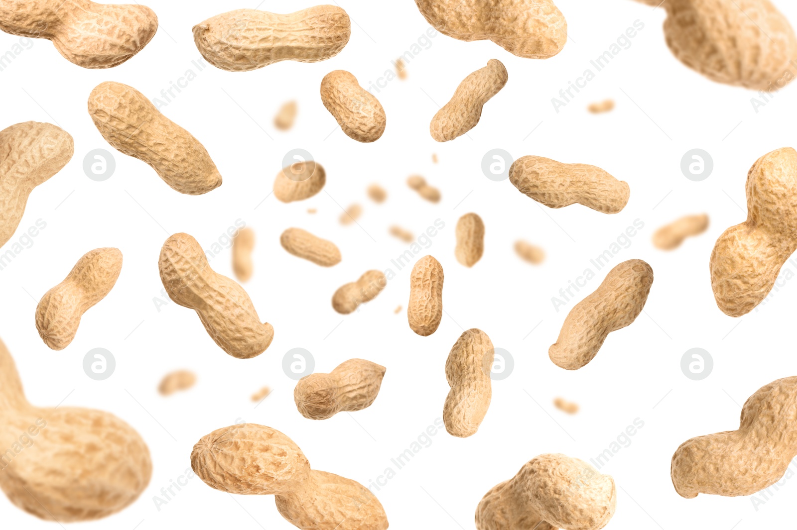 Image of Unpeeled peanuts in air on white background