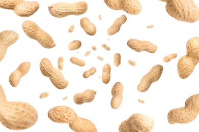 Image of Unpeeled peanuts in air on white background