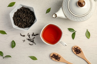 Flat lay composition with delicious tea on wooden background