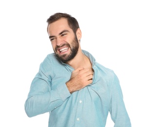 Young man scratching skin on white background. Annoying itch