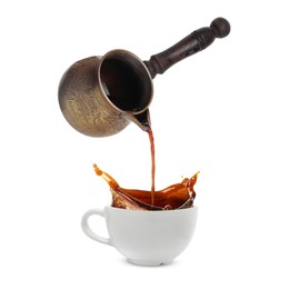 Pouring freshly brewed aromatic coffee from turkish pot into cup. Objects in air on white background