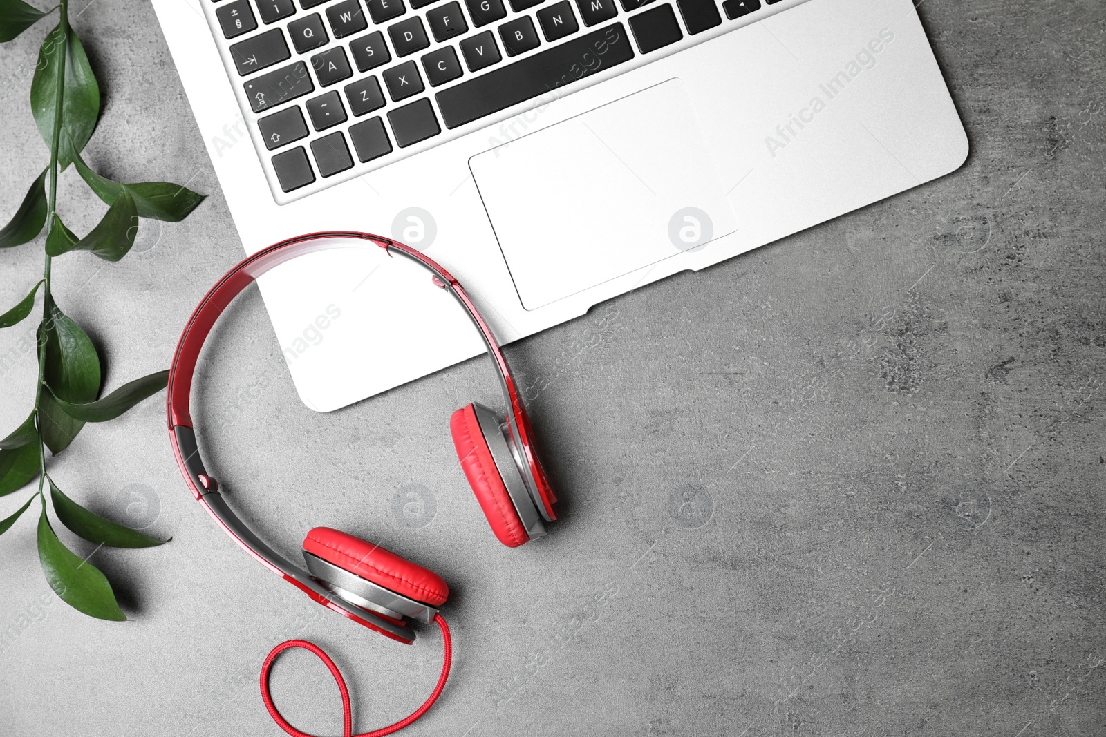 Photo of Flat lay composition with headphones, laptop and space for text on grey background