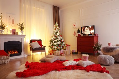 Image of Stylish living room interior with TV set, Christmas tree and fireplace