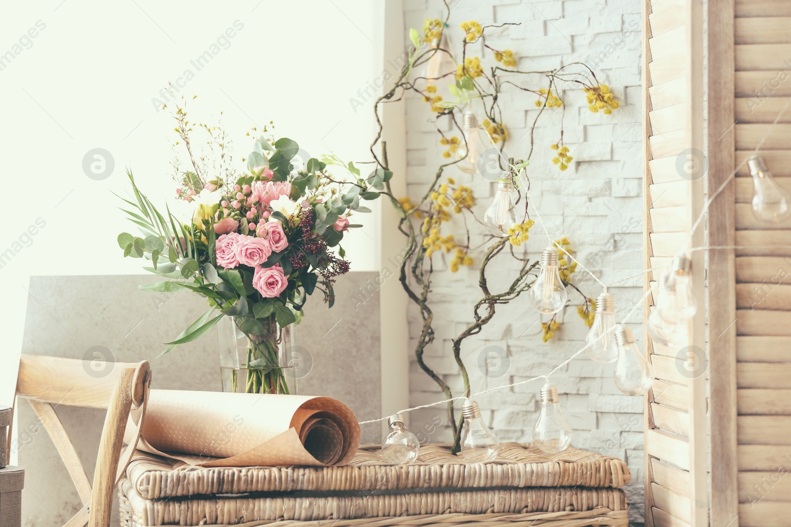 Photo of Decorator's workplace with beautiful flowers on table