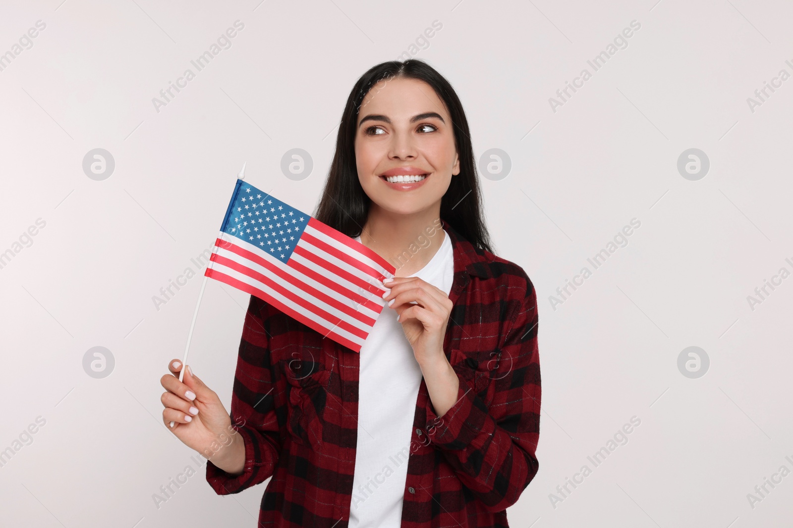 Photo of 4th of July - Independence Day of USA. Happy woman with American flag on white background