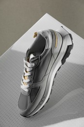 Photo of Stylish presentationtrendy sneaker against grey background