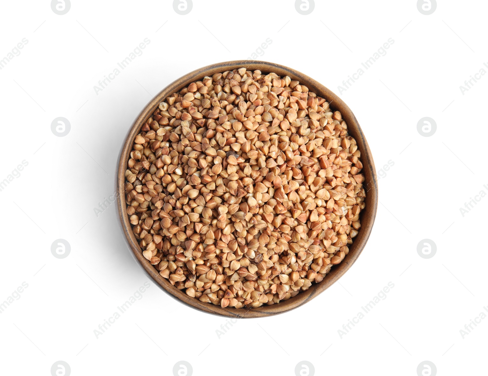 Photo of Bowl with uncooked buckwheat on white background, top view