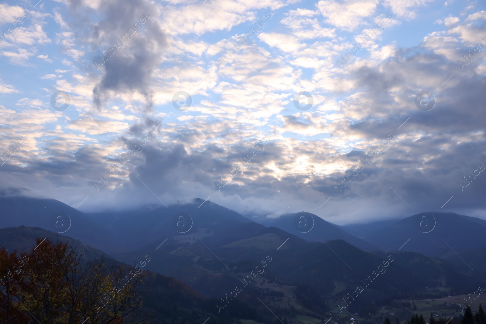 Photo of Beautiful view of mountains covered with fog and cloudy sky during sunrise